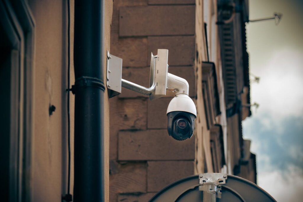 pexels photo 16746378 CCTV camera mounted on a building wall in an urban street setting, enhancing security.